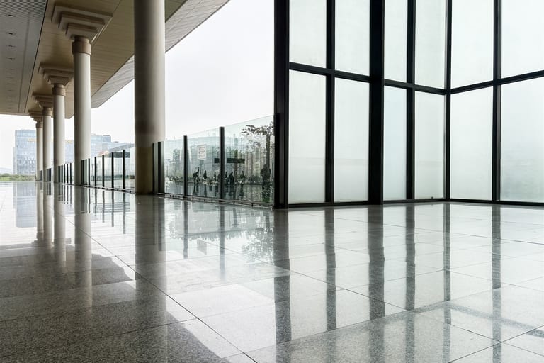 Bright commercial hall with reflective tile flooring