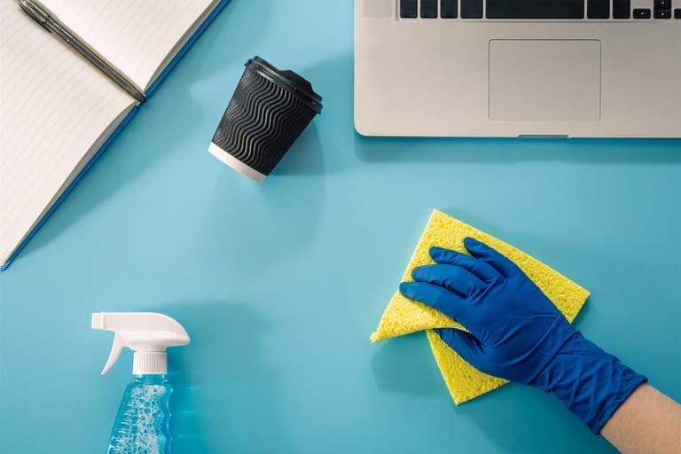 Cleaner wiping office desks in a Toronto office